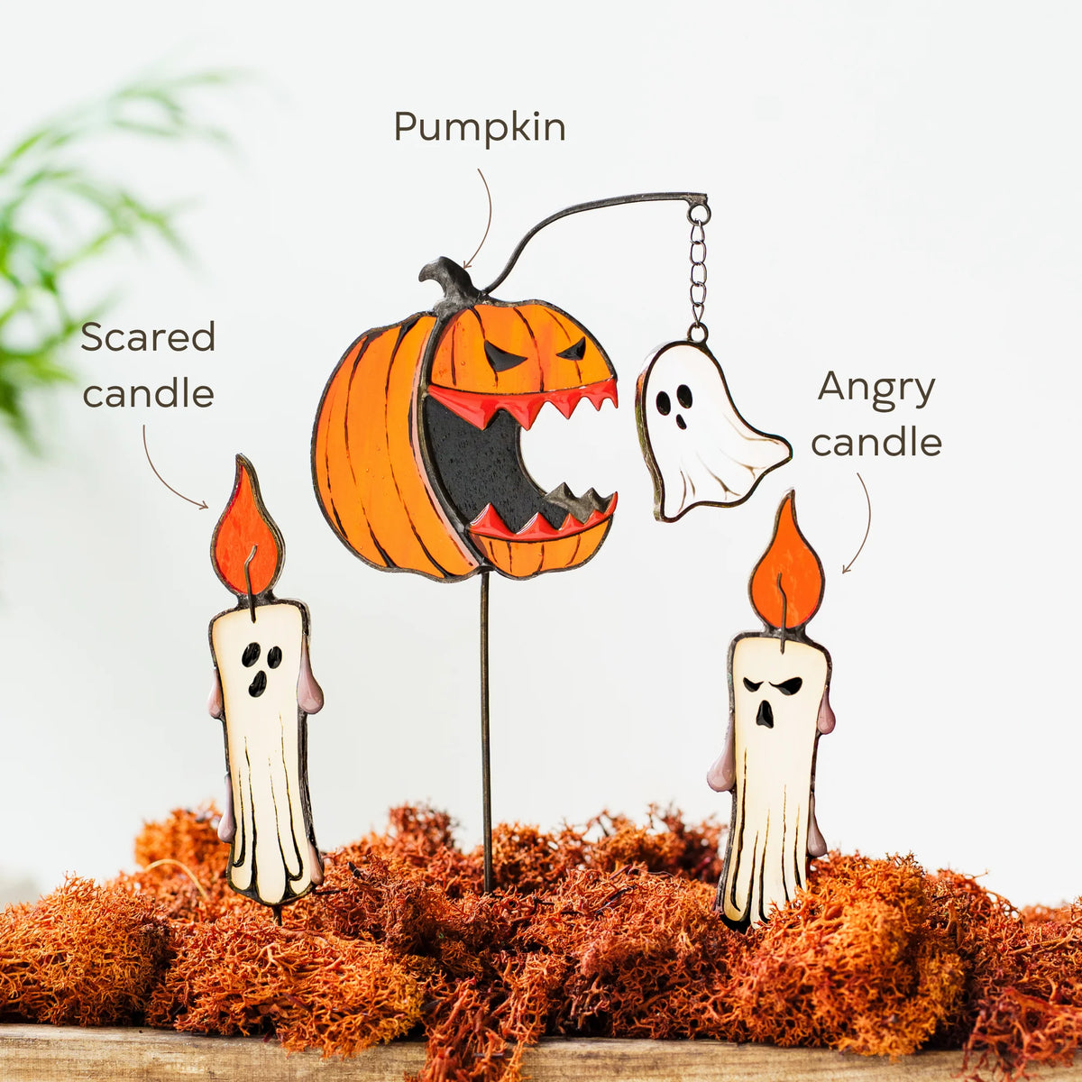 Halloween-themed stained glass set of plant stakes featuring a carved orange pumpkin, two ghost candles labeled 'Scared candle' and 'Angry candle,' and a hanging ghost with a chain labeled 'Pumpkin.'