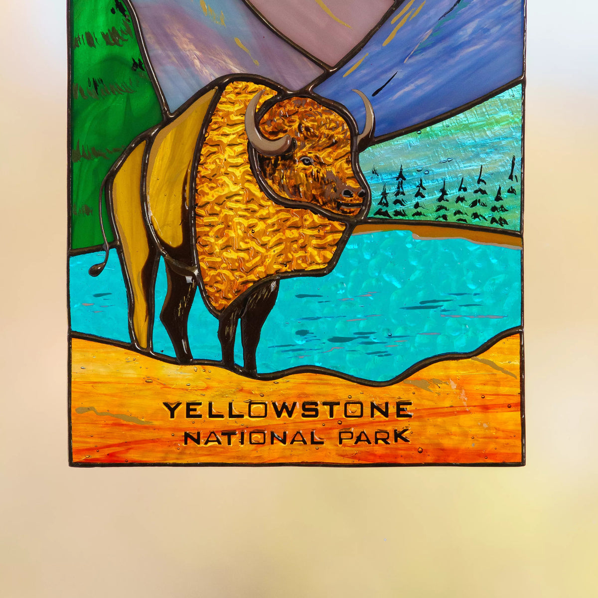 Stained glass panel with a bison and 'Yellowstone National Park' text on a beige background