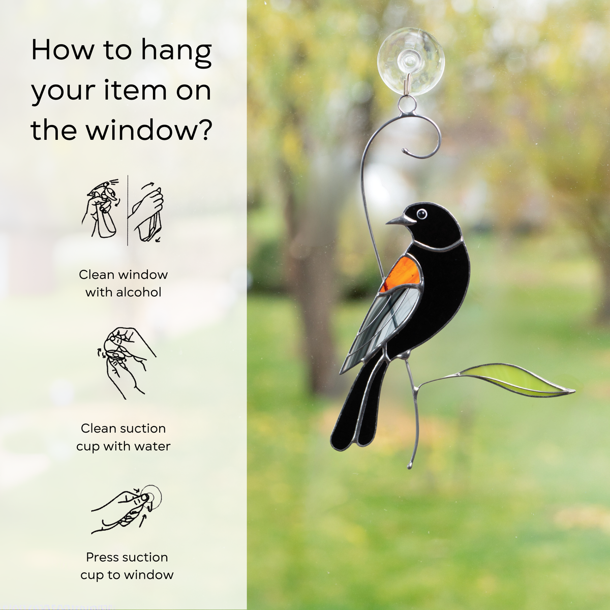 Stained glass blackbird with orange wing on a window, surrounded by simple instructions for hanging: clean window and suction cup, press a cup to the surface.