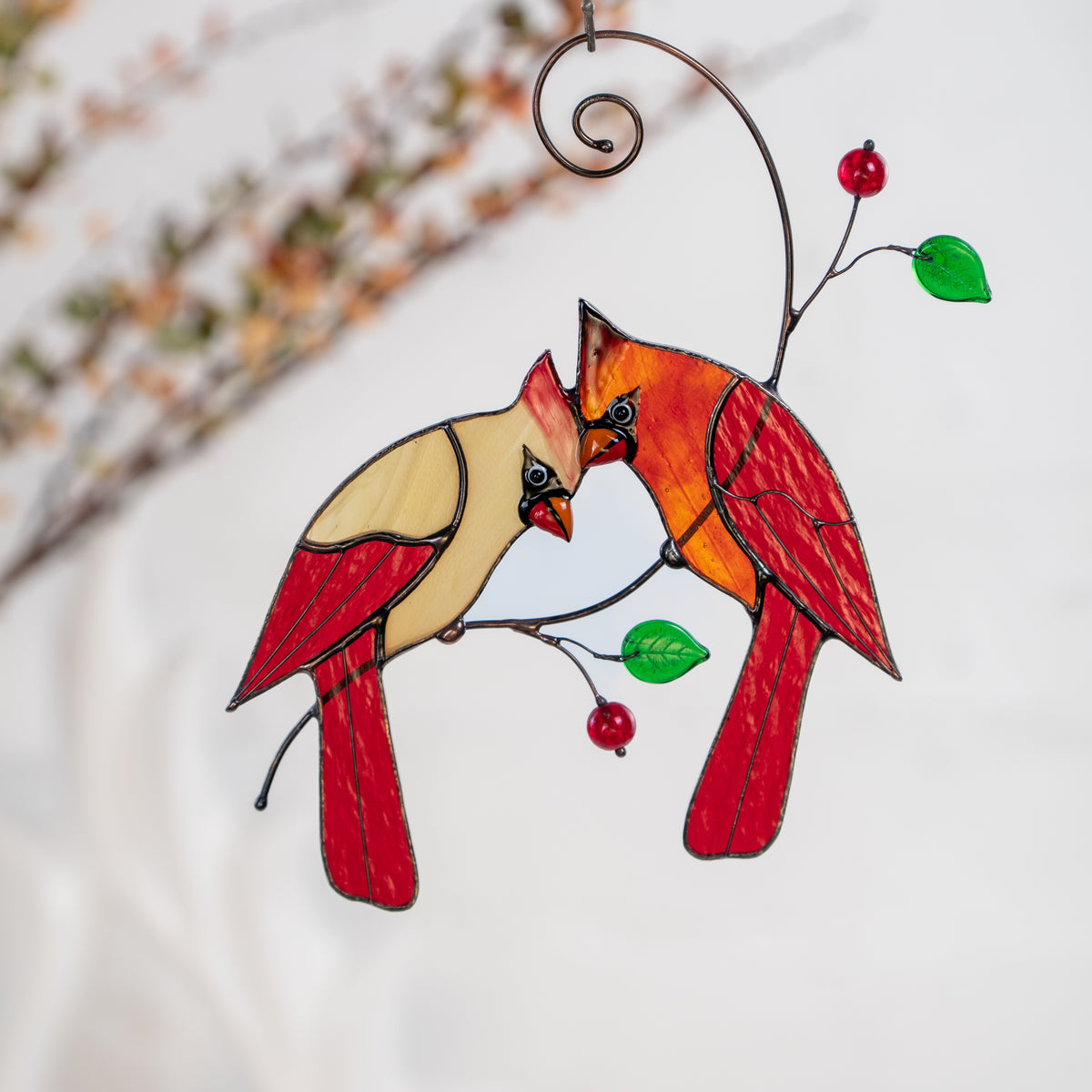 Hanging red cardinal suncatcher with green glass leaves and red beads