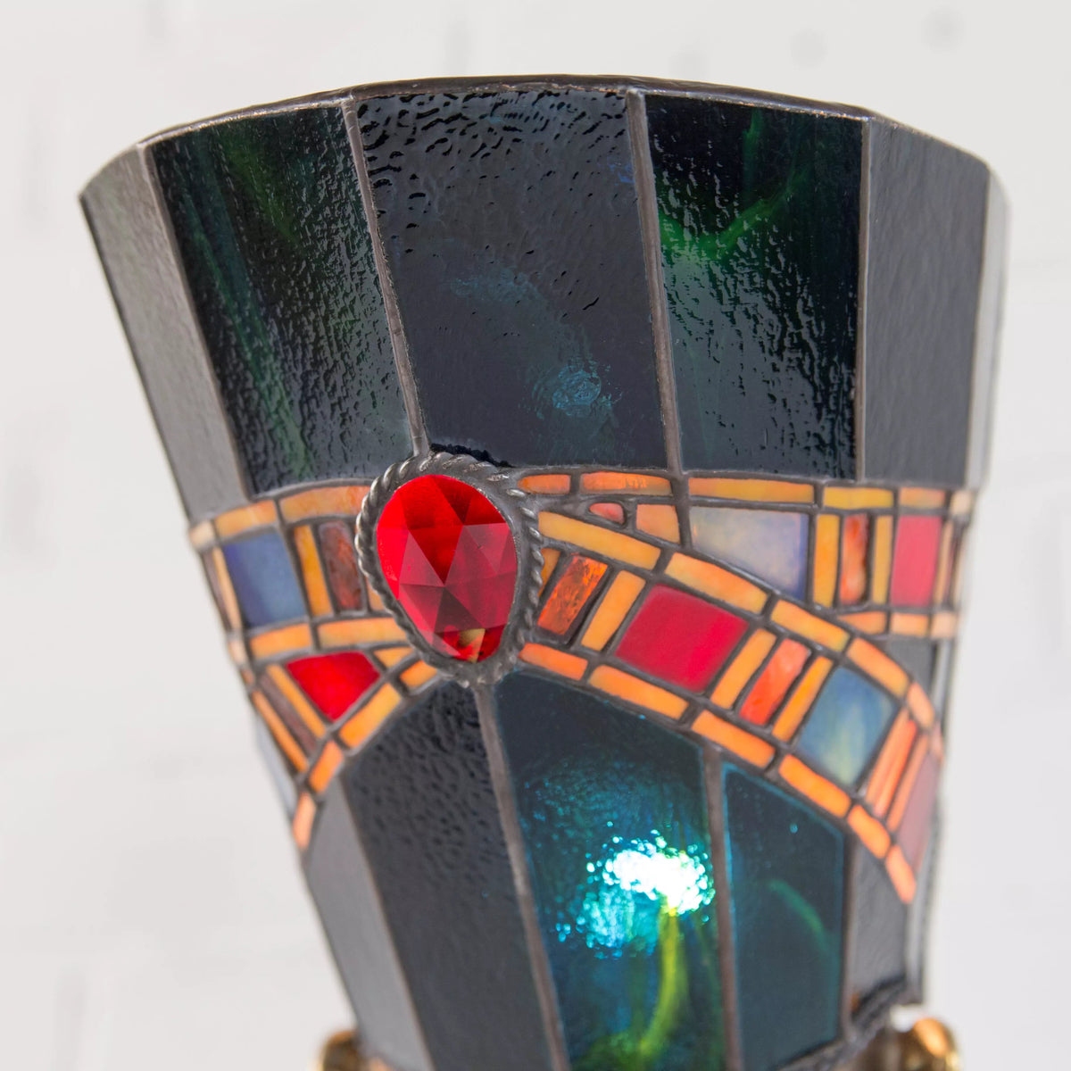 Close-up of back view of stained glass Nefertiti lamp with decorative faceted elements