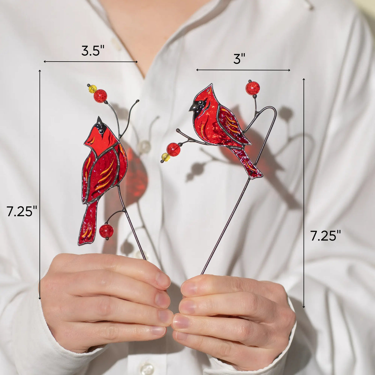 Dimensions of stained glass cardinal plant stakes: 3.5 x 7.25 and 3 x 7.25 inches