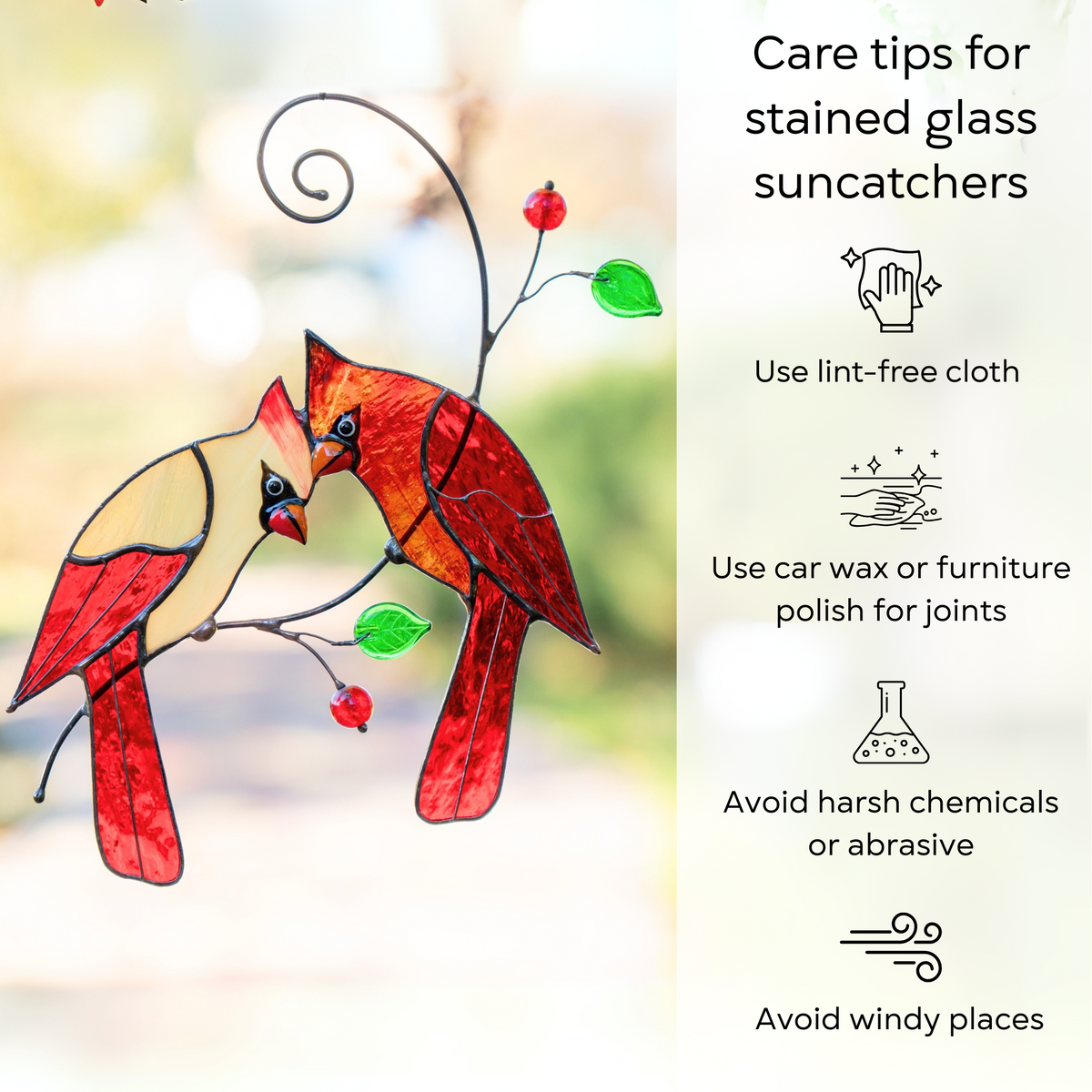 Two red stained glass cardinals perched on a branch with green leaves and red beads, care tips on right: use lint-free cloth, avoid chemicals and windy places