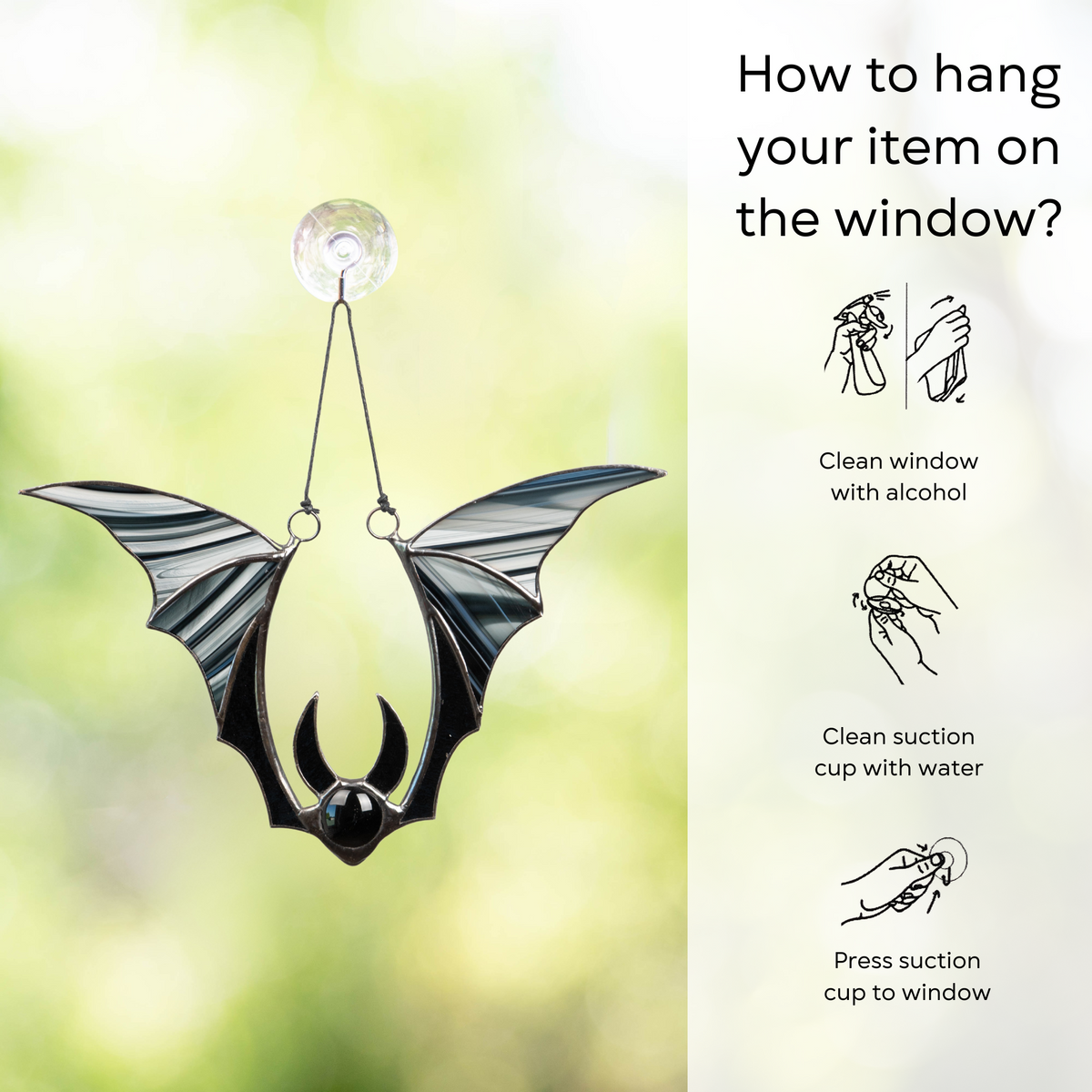 A black bat suncatcher attached to a window using a suction cup, with illustrated steps for hanging: clean window and suction cup, press a cup to the surface.