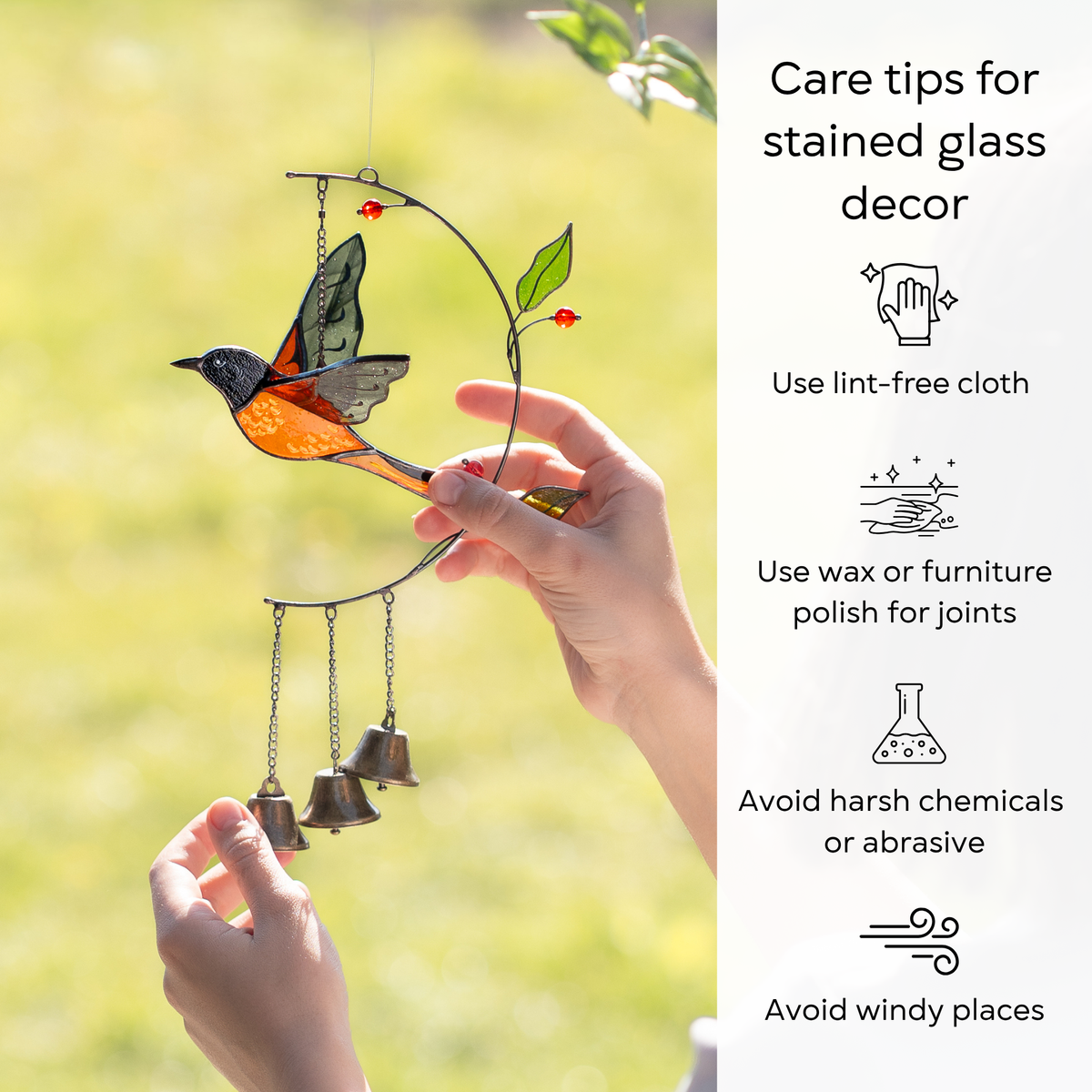 Stained glass bird decoration held by a hand with care tips on a blurred natural background: use lint-free cloth, polish joints with car wax or furniture polish, avoid harsh chemicals, and windy places.