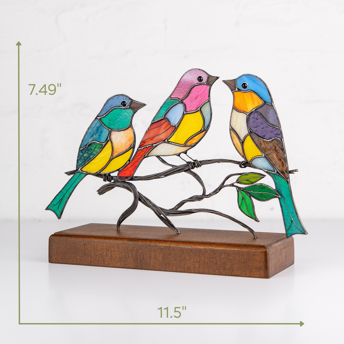 Glass art bird trio on wooden stand shown with height and width dimensions in inches.