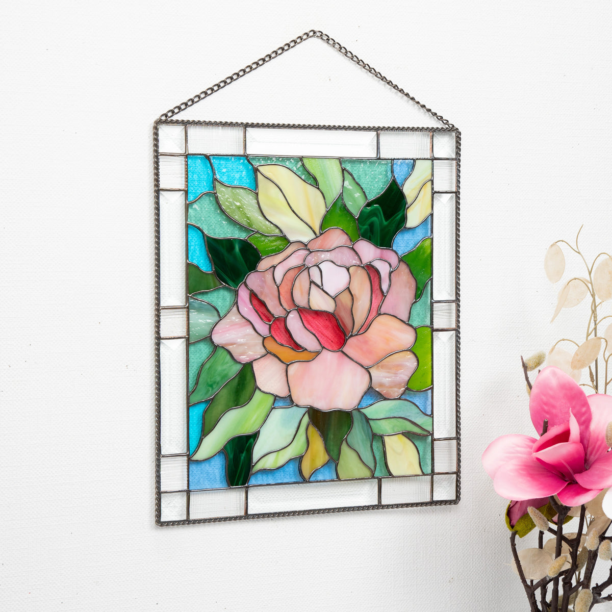 Stained glass panel with floral peony design on a white background