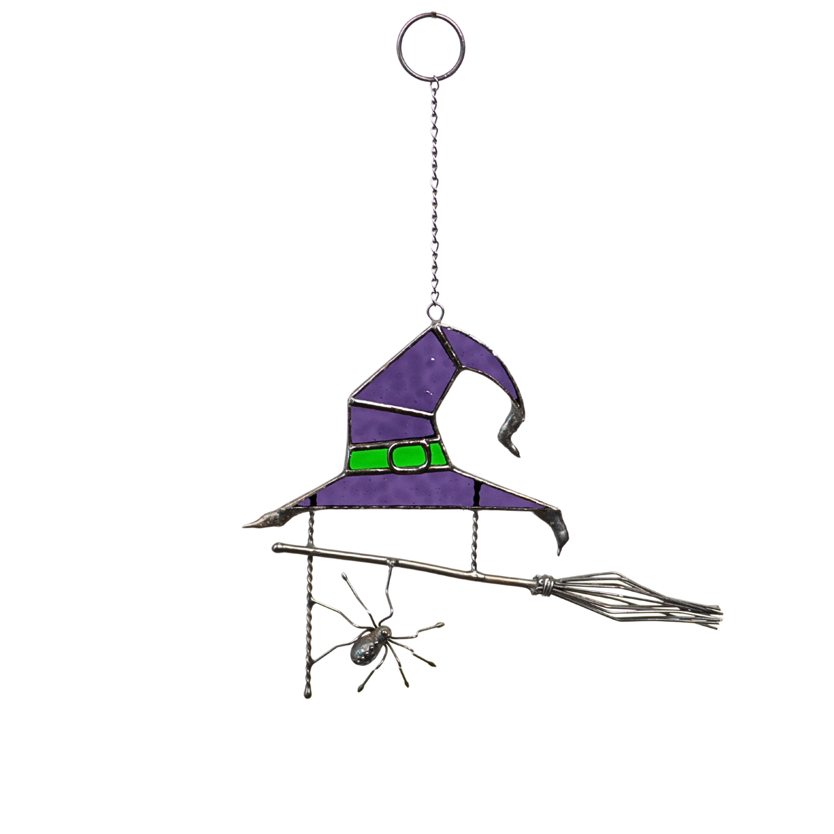 Purple stained glass witch hat with green detail, broom, and hanging spider shown on white background.