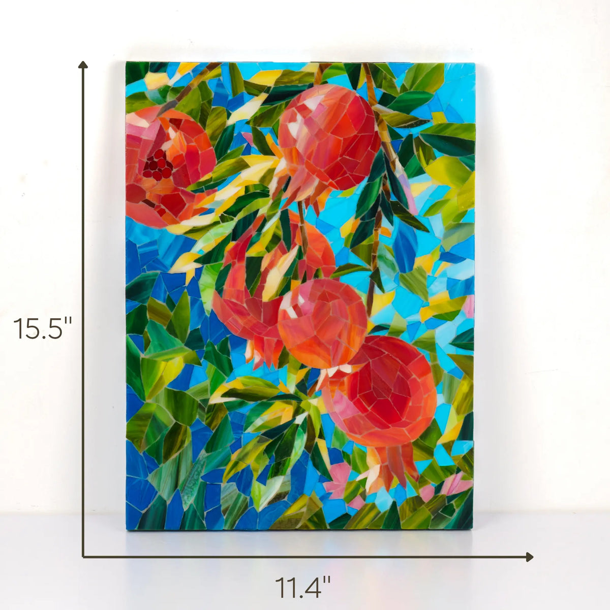 Pomegranate stained glass mosaic shown with its dimensions, 11.4 by 15.5 inches - sizing guide for this handmade hand-cut glass wall art with red pomegranates and green leaves on a blue glass background