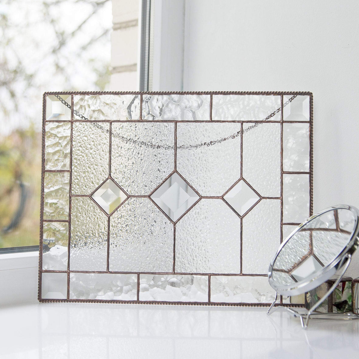 Clear panel of stained glass with three beveled inserts