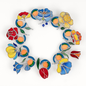 A circular stained glass design featuring colorful flowers