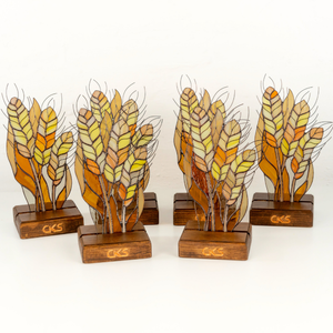 A collection of yellow, orange, and brown stained glass leaves
