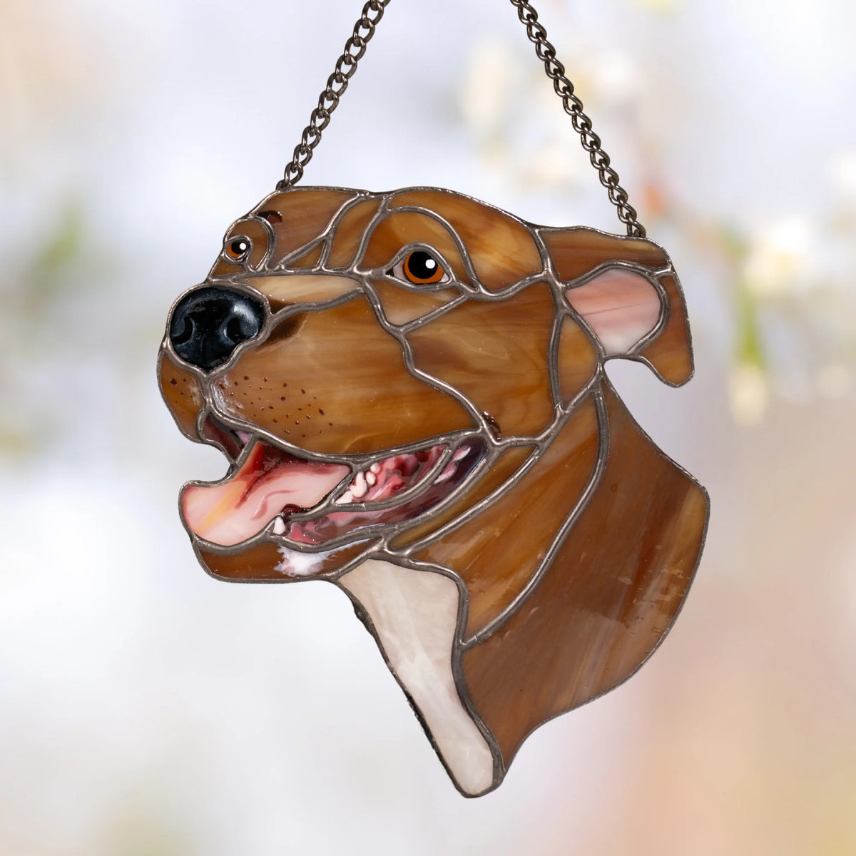 Custom pet portrait stained glass suncatcher of a smiling brown dog with amber eyes, pink tongue and cream chest, hanging on a dark chain - handmade from your photo as a gift for dog lovers