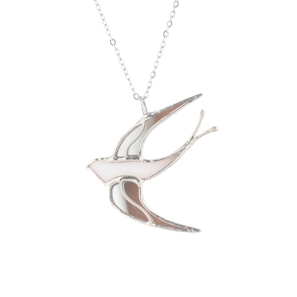 White Swallow stained glass necklace on a white background - a handmade flying swallow pendant in white and blush-pink glass with silver seams on a slim chain, delicate bird jewelry and a gift for bird lovers