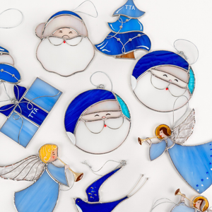 Christmas stained glass ornaments on a white workspace