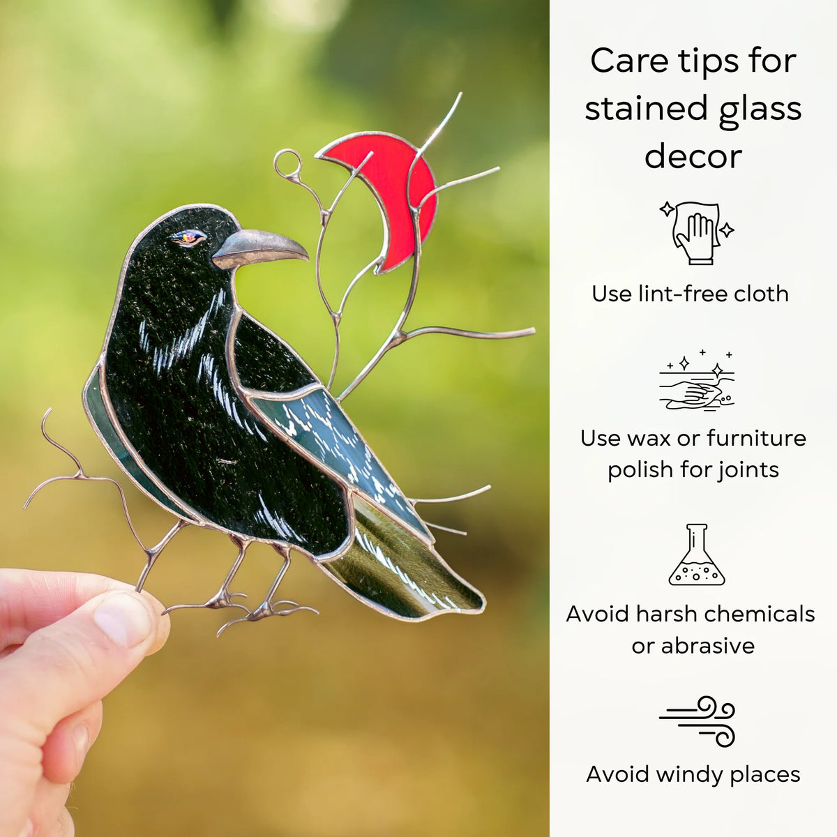 Care tips for a stained glass raven and red crescent moon suncatcher held outdoors - dust with a lint-free cloth, protect the joints with wax or furniture polish, and avoid harsh chemicals, abrasives and windy places
