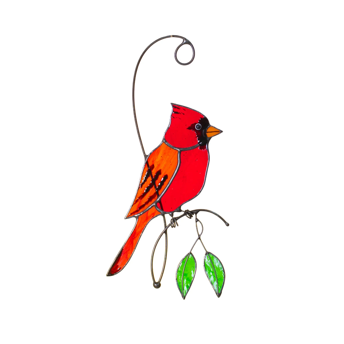 Handmade red cardinal stained glass suncatcher on a white background, a brilliant red cardinal with an orange wing perched on a wire branch with two green glass leaves - bird window decor