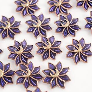A collection of purple flower-shaped stained glass pieces