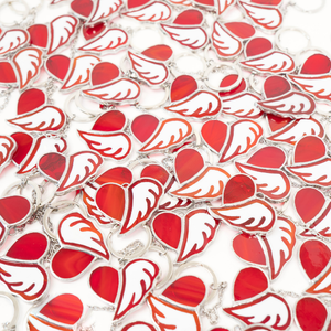 Red heart-shaped stained glass with white wings
