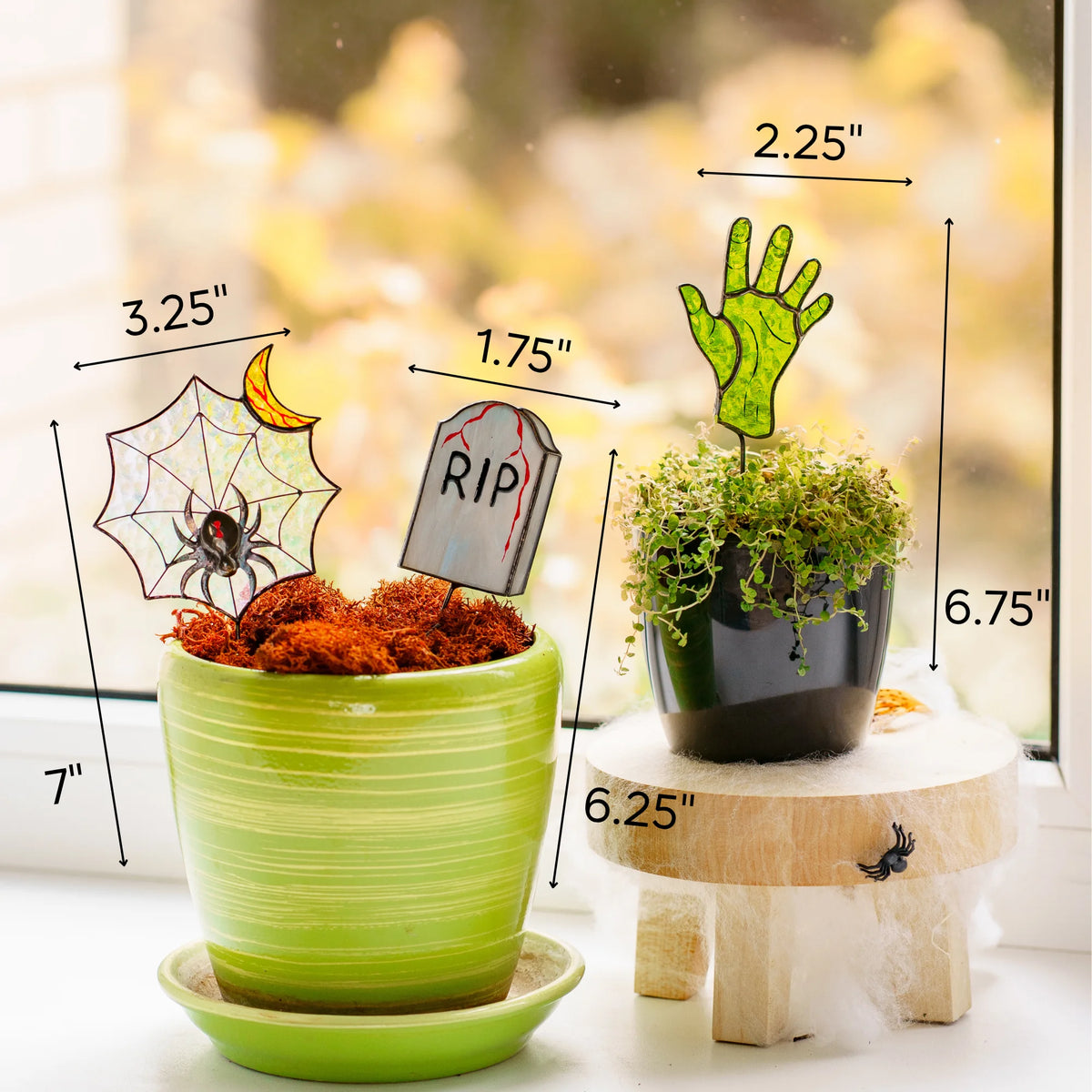 This dimensions infographic details the Halloween stained glass plant stakes: web sized 3.25 x 7 inches, tomb sized 1.75 by 6.25 inches, zombie hand sized 2.25 x 6.75 inches, showcasing them as a wonderful and memorable gift.