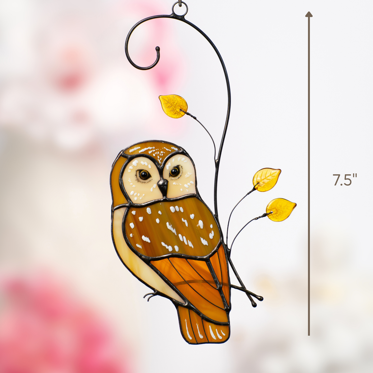 Stained glass owl with measurement marker and pink background, showing its height of 7.5 inches.