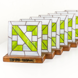 A series of stained glass awards with a geometric design with inscription U:Dep Division