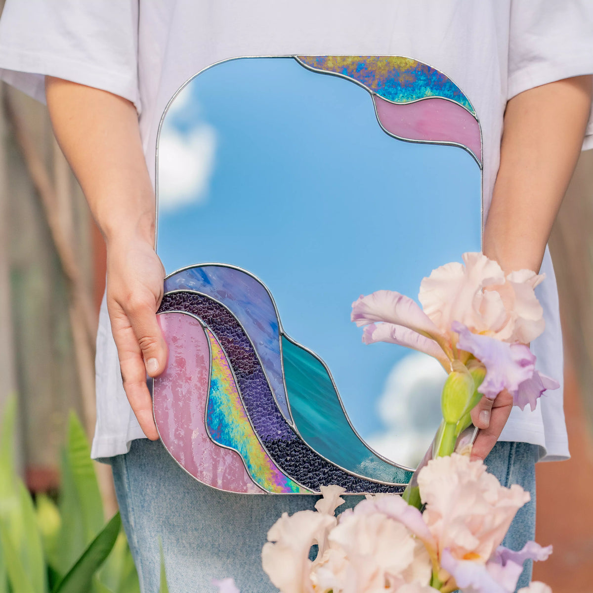 Stained glass mirror with purple wave frame displayed in an interior setting, handmade copper foil technique — artistic wall accent and a perfect gift for modern or eclectic homes