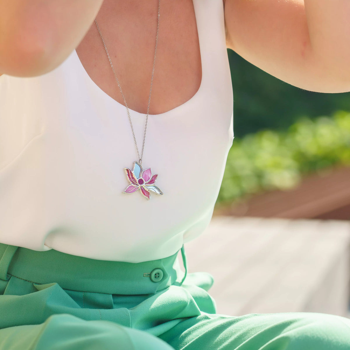 Pink lotus stained glass necklace worn long - a handmade lotus flower pendant with layered pink petals, spiritual botanical jewelry for everyday wear
