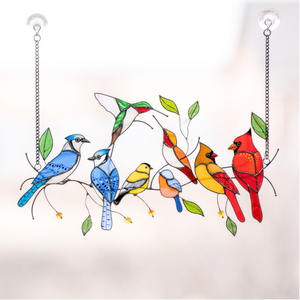 A colorful stained glass piece featuring birds perched on branches