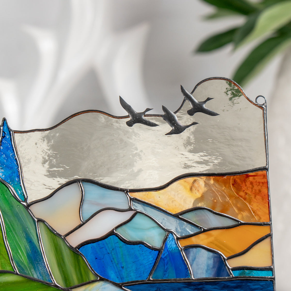 the ducks made of brass on the stained glass panel