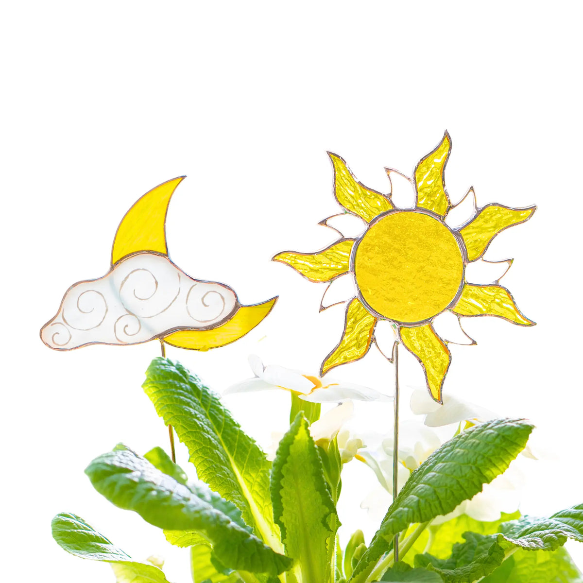 Stained glass plant stakes shaped like a sun and a cloud on a white background