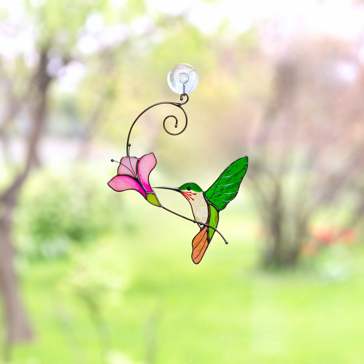 Handmade hummingbird suncatcher on the window