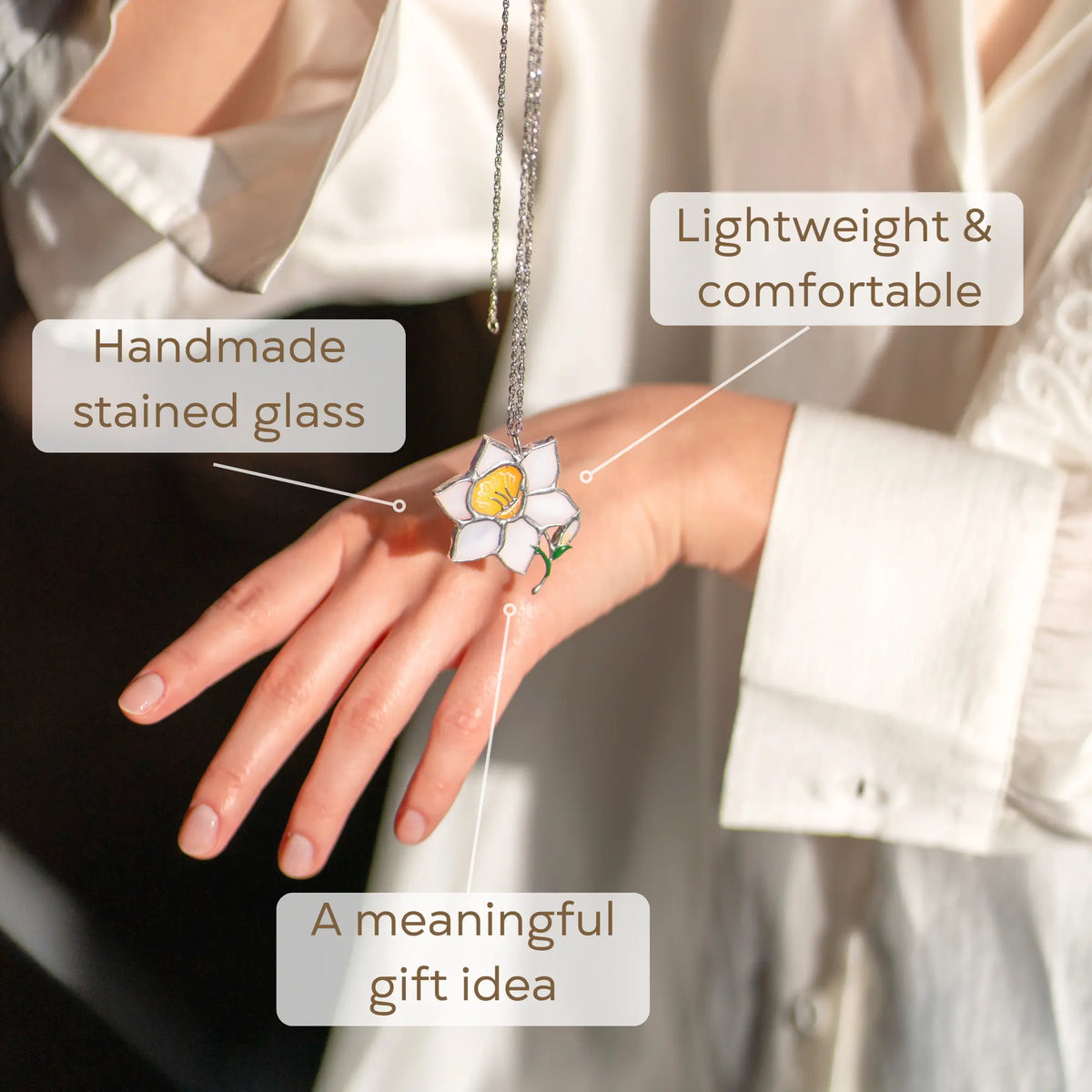 Handmade stained glass necklace on a hand as a meaningful gift idea