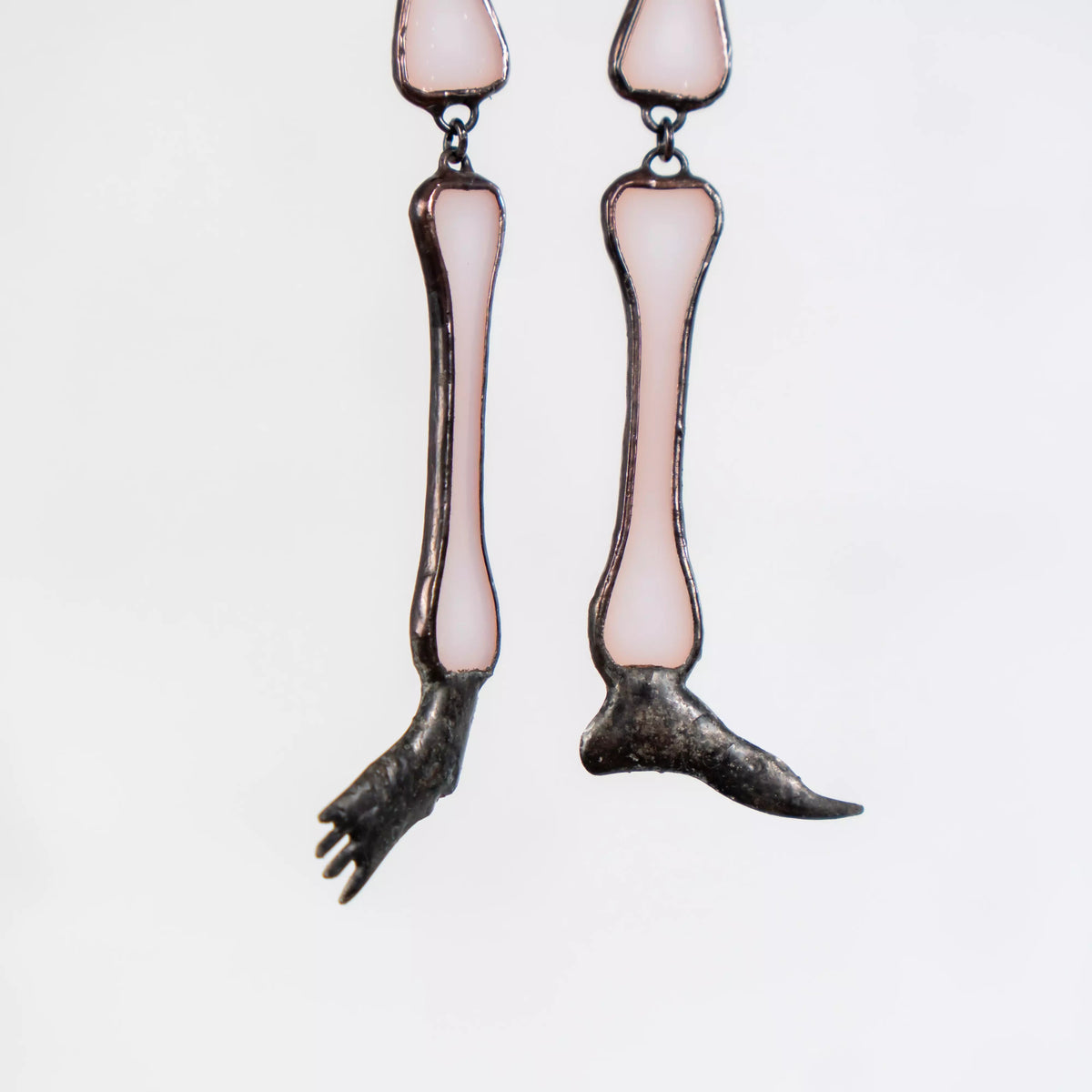 Close-up of skeleton’s feet and lower legs made from soft white stained glass
