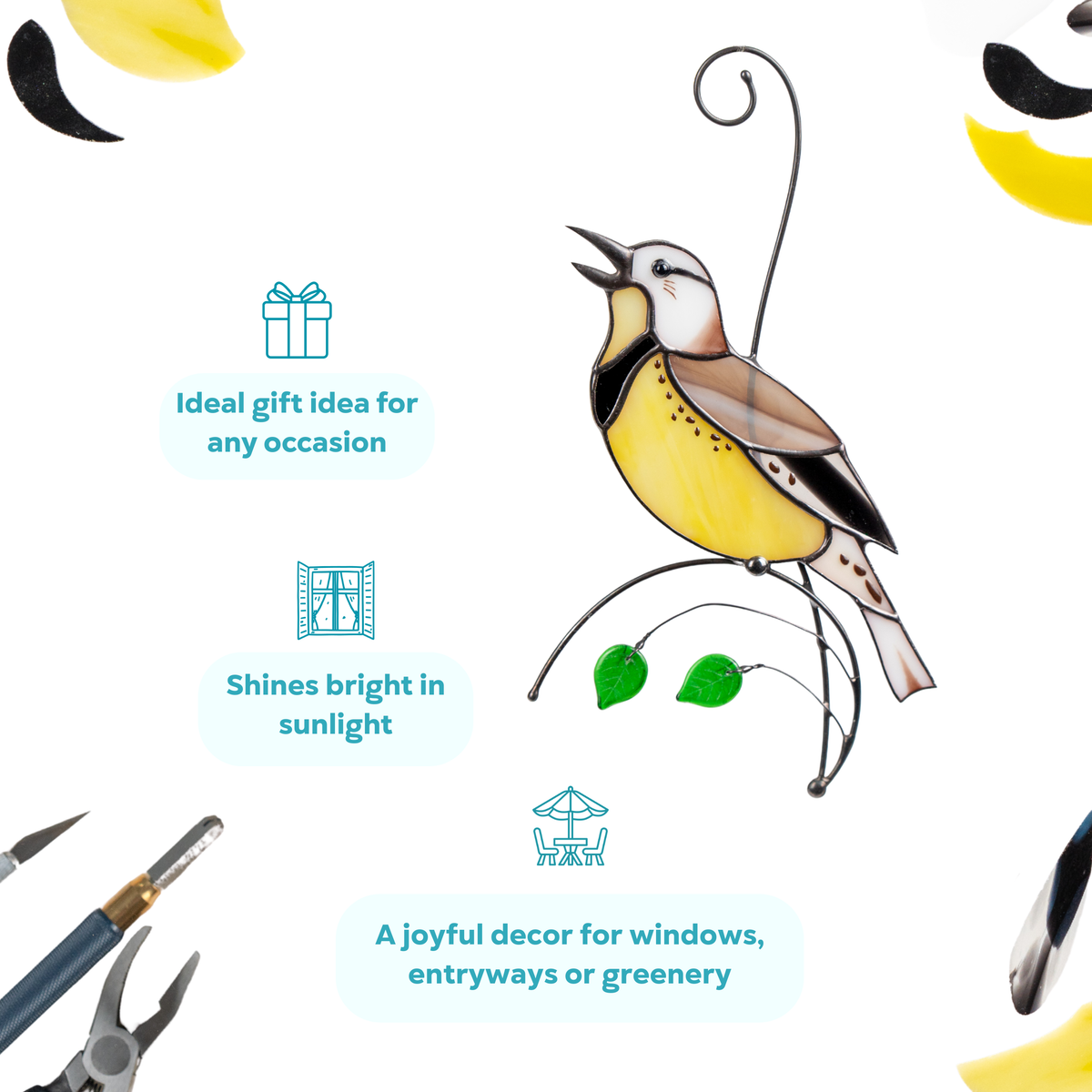Stained glass meadowlark with brown, yellow, and black wings and two hanging green leaves.