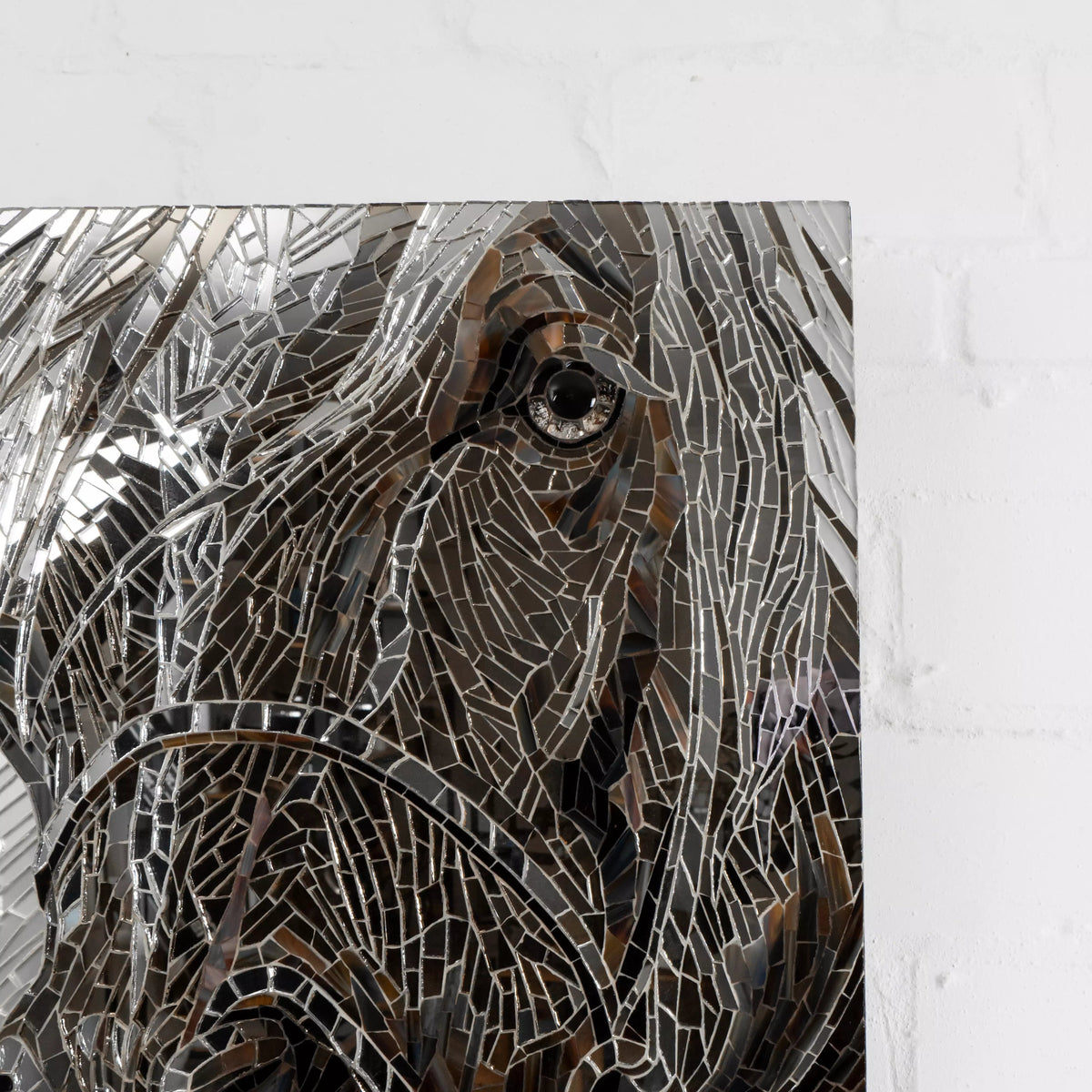 Close-up of a horse’s eye made of glass mosaic tiles in grey and brown tones
