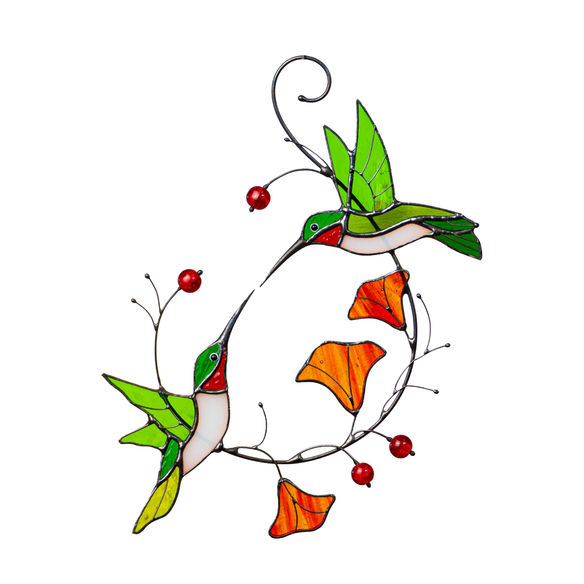 Stained glass hummingbird in green, red, and white flying toward an orange flower