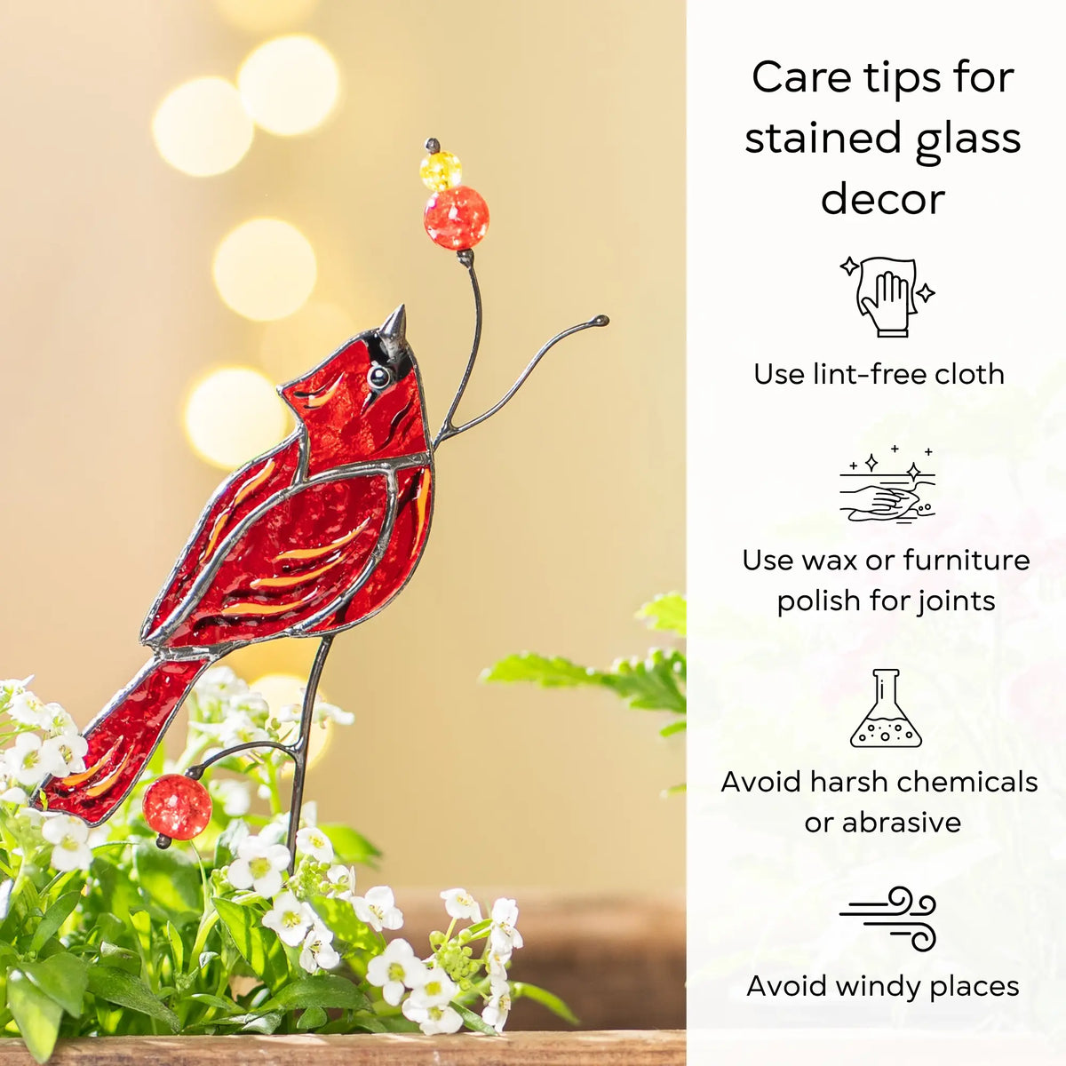 Stained glass cardinal bird plant stake with care tips on a blurred natural background: use lint-free cloth, polish joints with car wax or furniture polish, avoid harsh chemicals, and windy places.