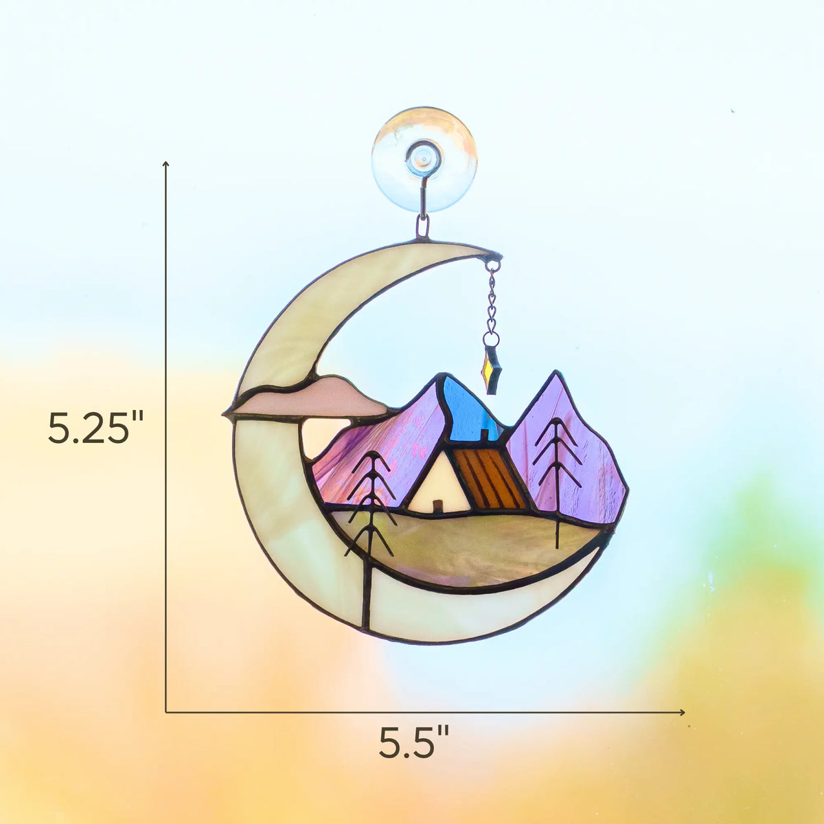 Stained glass suncatcher featuring a crescent moon, mountain landscape, and house with dimensions 5.25 x 5.5 inches