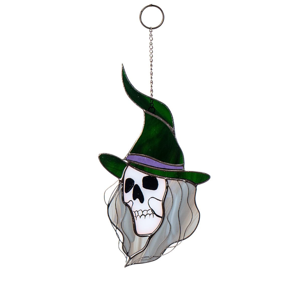 Stained glass witch with green hat and grey hair, hanging outdoors in a spooky Halloween setting