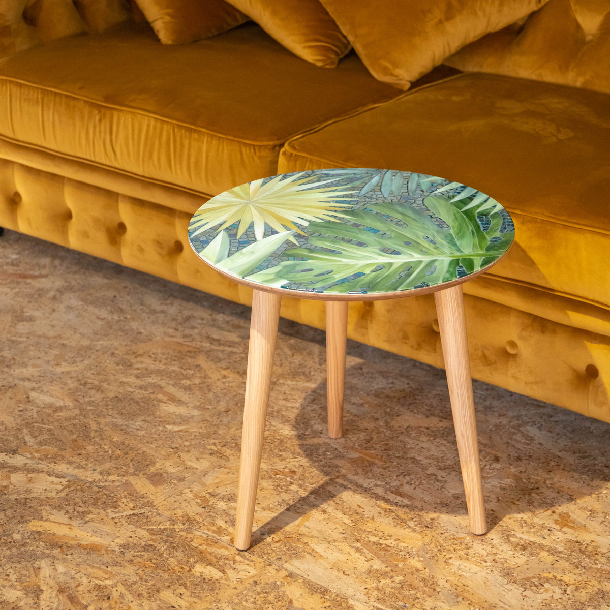Stained glass round mosaic table depicting monstera leaves